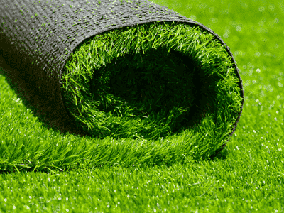Roll of artificial grass on floor - Pros and cons of artificial grass 
