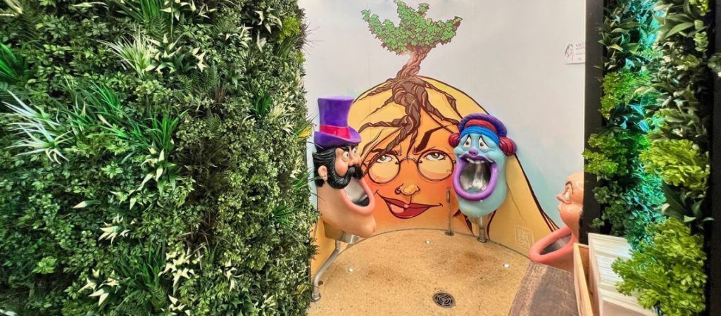 Artificial vertical garden panels add lush greenery to the wildly artistic washrooms