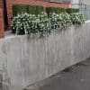 Hanging Artificial Flowering Plants for Outdoors with Boxwood Topiary Plants Along a Drive Way