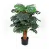Artificial Monstera plant with deep green leaves in a classic black pot.