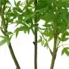 Close-up of the artificial bamboo plant's pot, showing detailed texture and soil topping