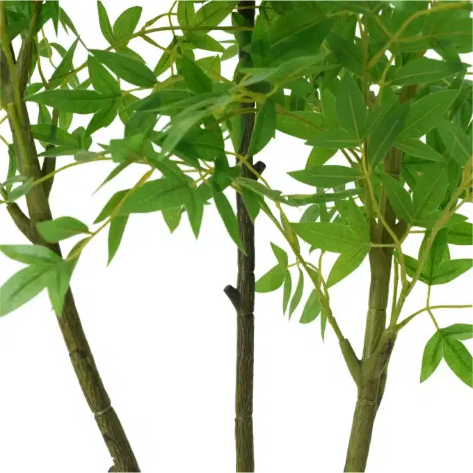 Close-up of the artificial bamboo plant's pot, showing detailed texture and soil topping
