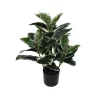 The base of an artificial Ficus plant, focusing on the black pot and the realistic brown stems with variegated foliage above.