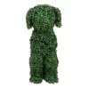 Green leafy topiary dog sculpture sitting in a garden. A stunning piece of garden art with intricate foliage, adding charm to any outdoor space