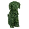 Topiary dog sculpture made from vibrant green leaves. This exquisite garden art piece stands out with its detailed and lifelike appearance.