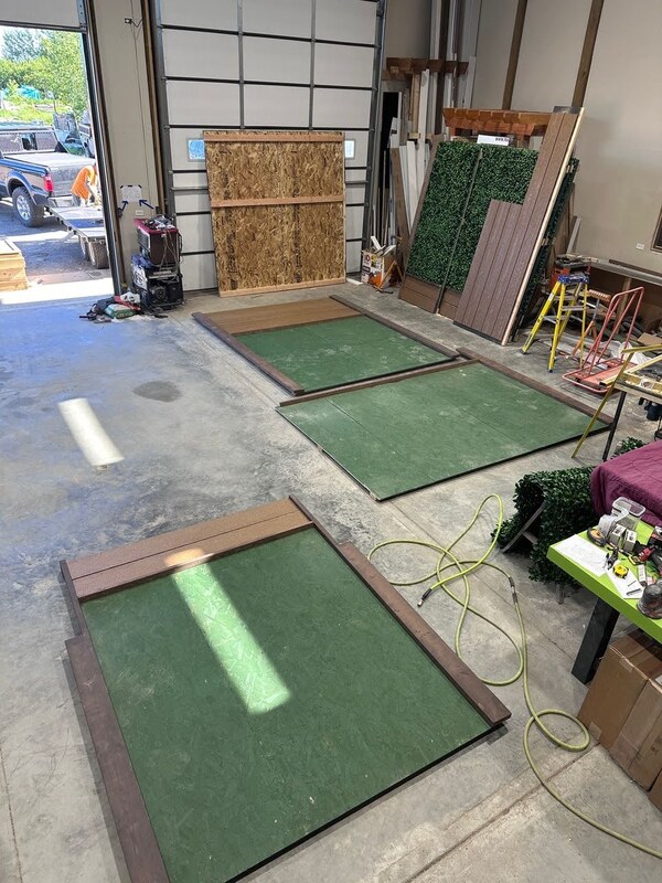 building up fake Jasmine green wall with wooden boards