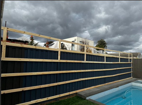 the process of installing green wall panels on colourbond fence