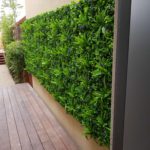 Artificial green wall near a kitchen with fake green walls