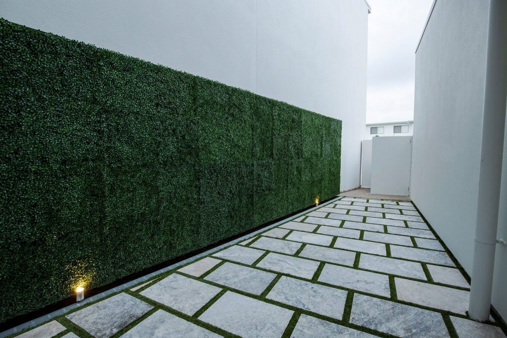 Artificial Boxwood Panels Along A Side Wall - Designer Plants®