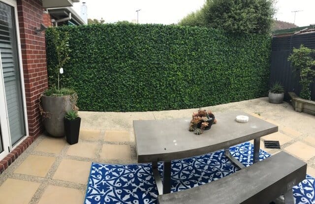 Fake hedge wall in backyard and patio area - mixed fake ivy wall ...