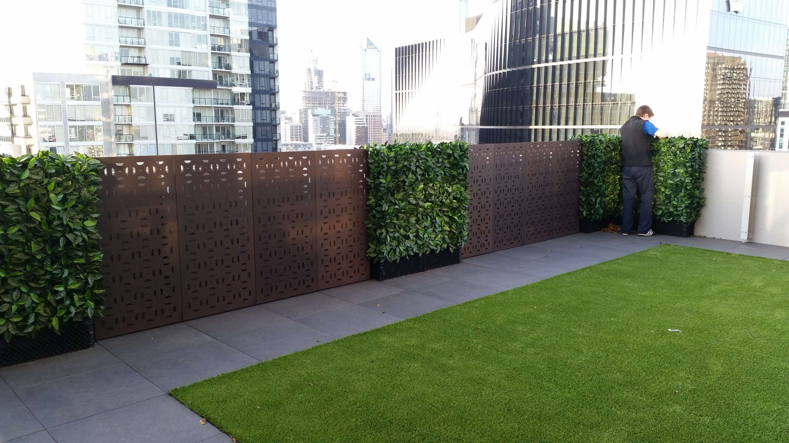 After - Artificial Photinia hedge panels were installed along a balcony