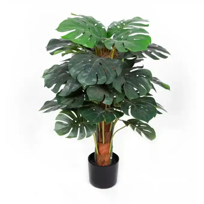 Artificial Monstera plant with deep green leaves in a classic black pot.