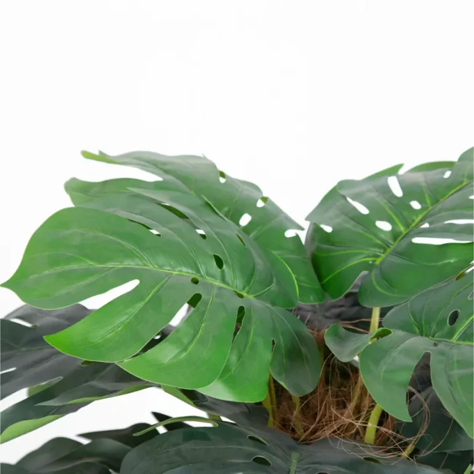 Durable silk Monstera with lifelike foliage, ideal for enhancing office spaces.